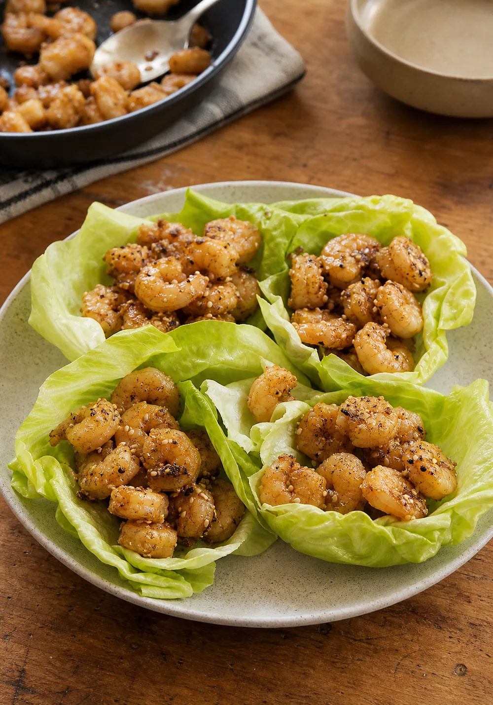 Sesame salt-and-pepper shrimp in crisp lettuce cups.